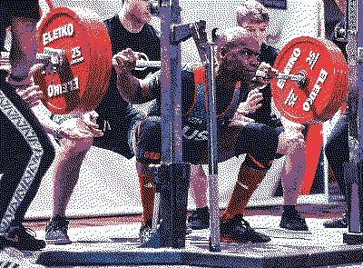 Powerlifter performing a low-bar squat in competition