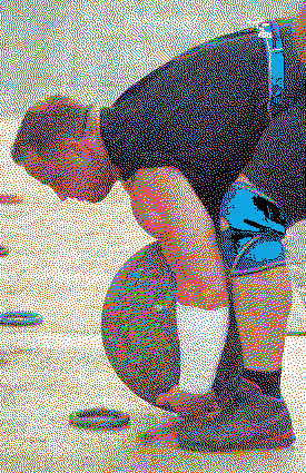 A lifter performing a trap-bar deadlift with a rounded back